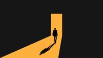 Silhouette of Businessman Entering Lit Door Passage in Darkness
