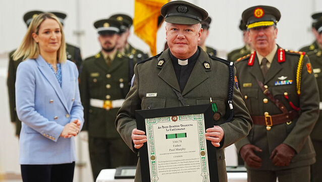<p>Minister for defence Helen McEntee (left) and Chief of Staff, Lieutenant General Rossa Mulcahy (right) after Father Paul Murphy (centre) was presented with the Distinguished Service Medal, with merit, at Dun Ui Mhaoiliosa in Renmore Barracks on Thursday. Photo: Brian Lawless/PA</p>