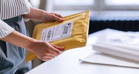 An Unrecognizable Businesswoman Preparing A Package For Shipping