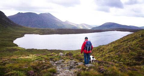 Man walking in the Mourne mountains in Northern Ireland - Stock photo