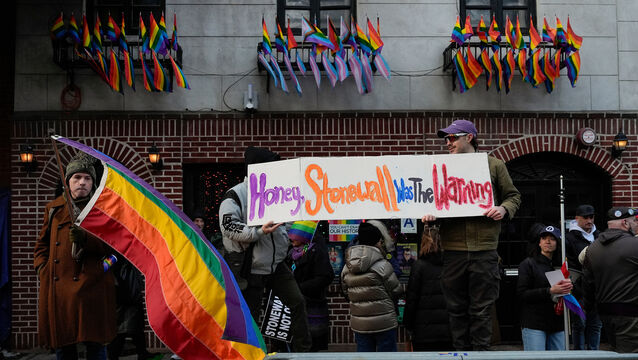 People demonstrate outside the Stonewall Inn after New York politicians and activists raised a rainbow flag (Yuki Iwamura/AP)