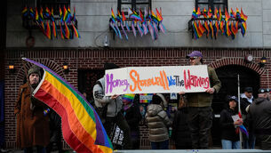 People demonstrate outside the Stonewall Inn after New York politicians and activists raised a rainbow flag (Yuki Iwamura/AP)