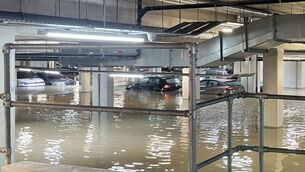 <p>Cars stand in flood water in an underground car park in north Dublin which flooded after heavy rain overnight. Picture: Grainne Ni Aodha/PA Wire</p>