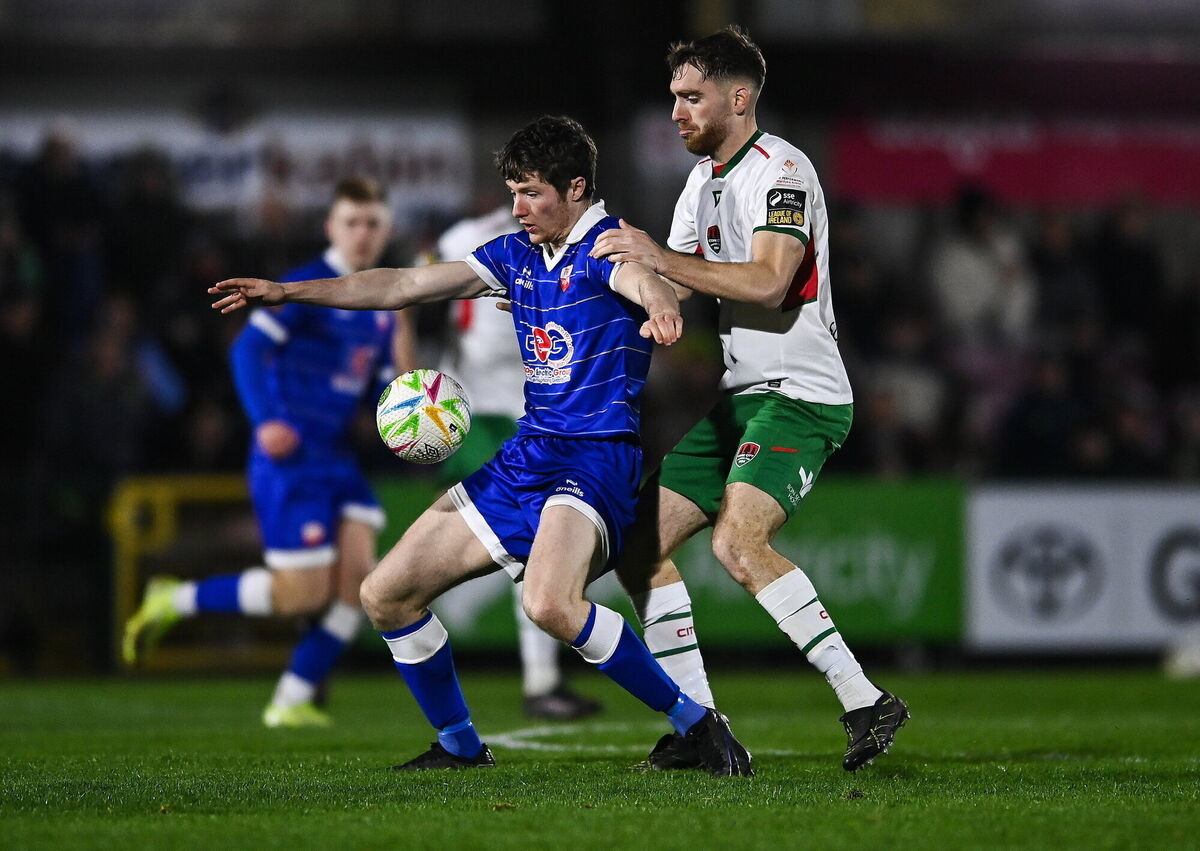 Ben Feeney of Treaty United holds off Conor Drinan. Pic: Matt Browne/Sportsfile Ben Feeney of Treaty United holds off Conor Drinan. Pic: Matt Browne/Sportsfile