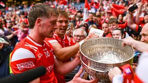 <p>Louth players Ciarán Byrne and Conor Grimes, behind, with the Delaney Cup after victory in the Leinster GAA Football Senior Championship final match between Louth and Meath at Croke Park in Dublin. Photo by Piaras Ó Mídheach/Sportsfile</p>
