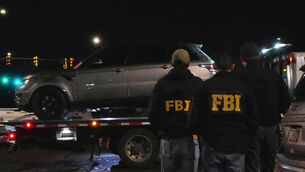 Pima County sheriff and FBI agents take away a Range Rover from a Culver’s parking lot in Tucson, Arizona (Ty ONeil/AP)