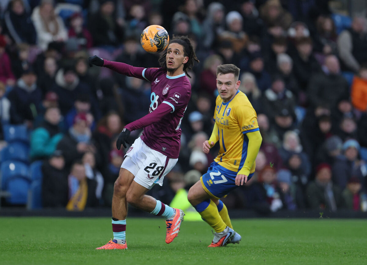 Burnley's Hannibal Mejbri (left) and Mansfield Town's Luke Bolton (right) battle for the ball. Pic: Richard Sellers/PA
