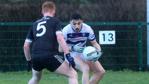<p>Aaron West, Ballyphehane, in possession of the ball against Alan Buckley, Knockainey. Pic: Brendan Gleeson</p>