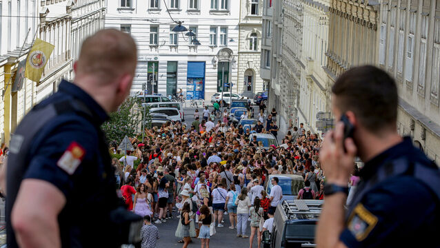 Austrian police officers watching as Taylor Swift fans gathered in on August 8 2024 (Heinz-Peter Bader/AP)