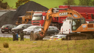 <p>Gardaí oversee a digger excavating at the scene of a search in Co Wicklow in connection with the murders of Jo Jo Dullard and Deirdre Jacob who went missing in the 1990s. Picture: Niall Carson/PA</p>