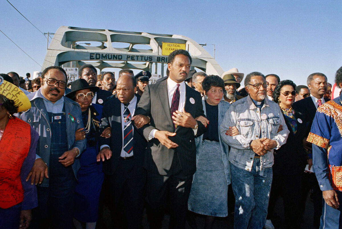  In this March 4, 1990, file photo, civil rights figures lead marchers across the Edmund Pettus Bridge during the recreation of the 1965 Selma to Montgomery march in Selma, Ala.  Picture: AP Photo/Jamie Sturtevant, File