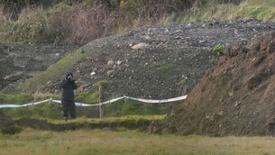 <p>A Garda forensic photographer takes pictures at the scene of the searc. Picture: : Niall Carson/PA Wire</p>