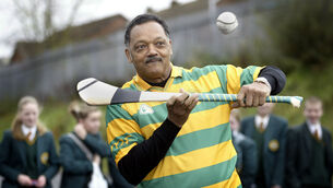 <p>American civil rights campaigner Rev Jesse Jackson trying hurling during his visit to Irish Language School, Meanscoil Feirste in West Belfast in 2004. File picture: Alan Lewis</p>