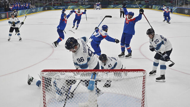 The fugitive was arrested when he turned up support Slovakia, wearing dark blue, at the Olympics (Alexander Nemenov/Pool Photo via AP)