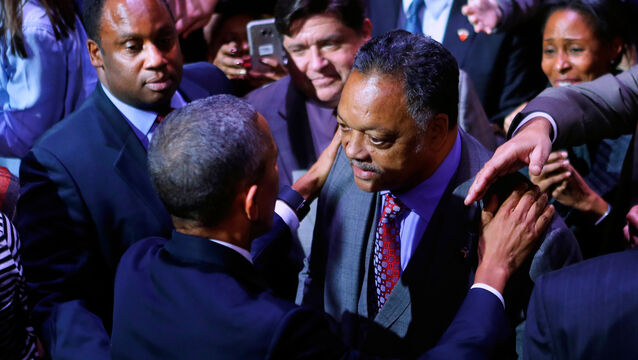 <p>Barack Obama talking to Rev Jesse Jackson (AP)</p>