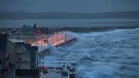 Giant waves and violent storm jumping over the pier in the seaside town of Tramore, Waterford, Ireland. horizontal format