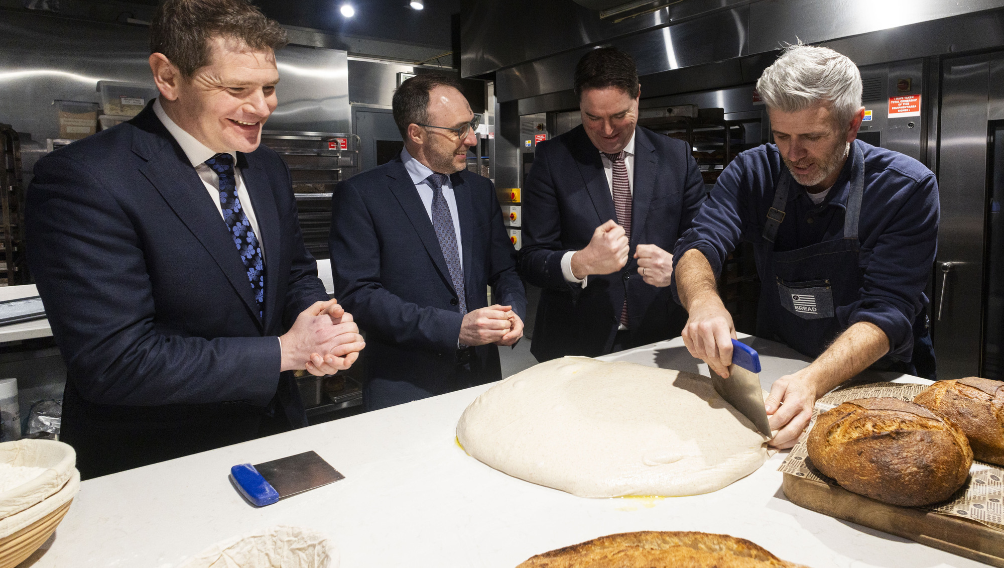Why does the Government want to help build four new flour mills?