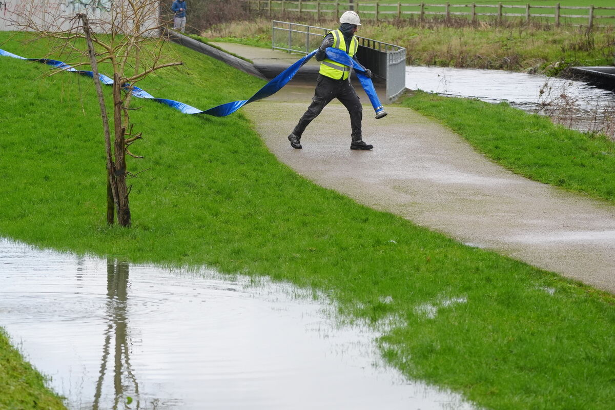 Uisce Éireann workers prepare to pump flood water from an underground car park in north Dublin which flooded after heavy rain last week.