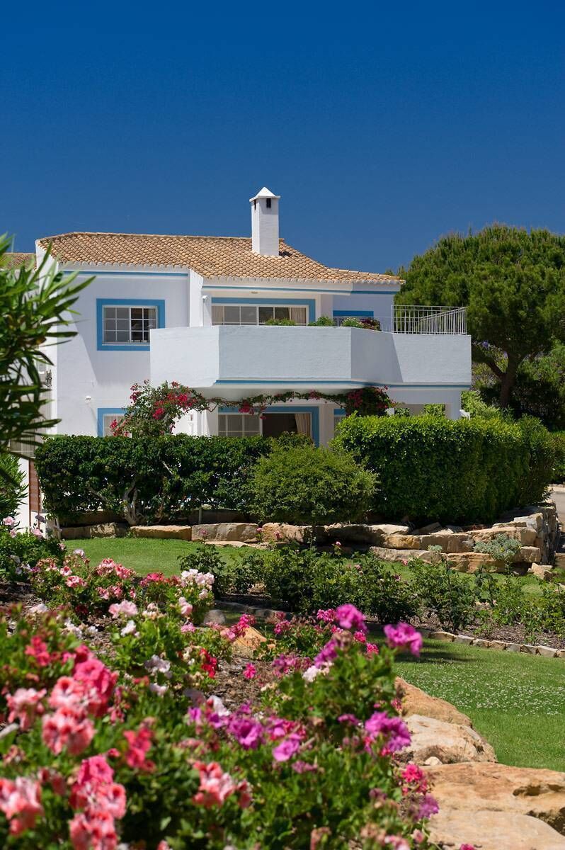 A villa with lush flowers and greenery at Four Seasons Fairways