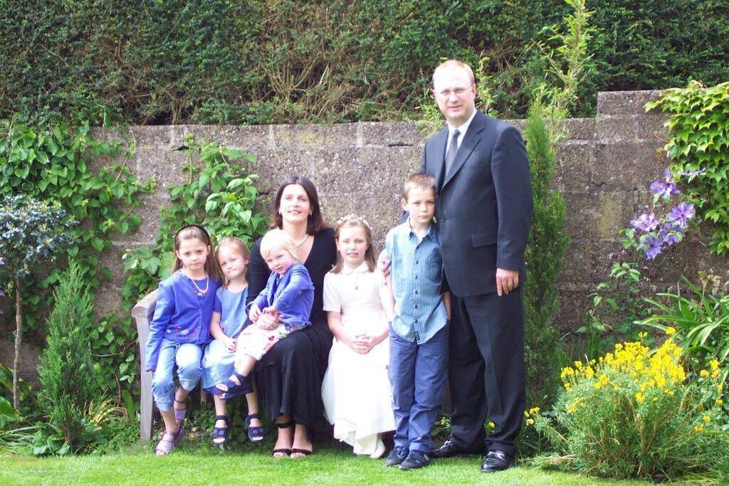 Left: Niamh, Neassa, Roisin, Aoife, and Cian celebrating Aoife’s communion in 2002 with parents Miriam and Aonghus.
