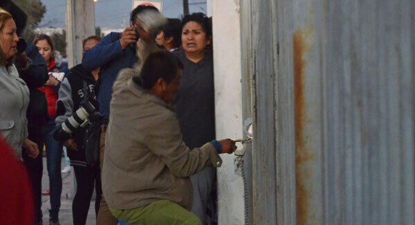 A man tries take the handcuffs of a policeman standing inside the Topo Chico prison, where a riot broke out just around midnight, in Monterrey, Mexico, Thursday, Feb. 11, 2016.AP photo. A man tries take the handcuffs of a policeman standing inside the Topo Chico prison, where a riot broke out just around midnight, in Monterrey, Mexico, Thursday, Feb. 11, 2016.AP photo.