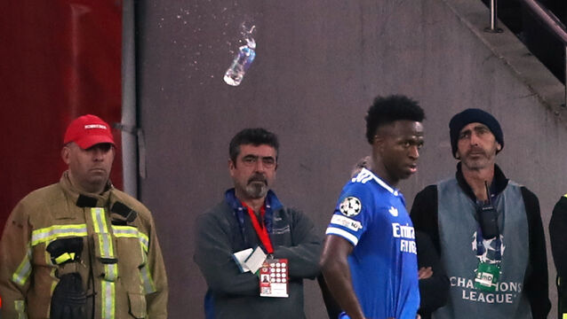 <p>A plastic bottle filled with water is thrown from the stands toward Real Madrid's Vinícius Júnior during a Champions League playoff soccer match between Benfica and Real Madrid in Lisbon, Portugal, on Tuesday. Picture: Pedro Rocha/AP</p>