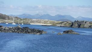 <p>Sailboats shelter in Inishbofin Harbour, with the ruins of Cromwell’s Barracks on the right.</p>