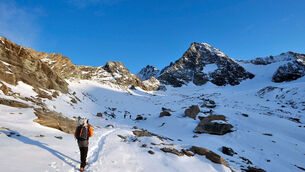 A walker on his way to the cross on the summit of the Grossglockner mountain (Kerstin Joensson/AP)