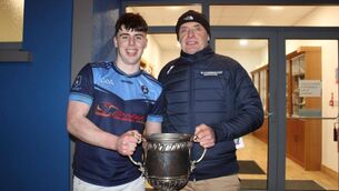<p>St Gerald's captain Evan Walsh receiving the Aonghus Murphy Cup following Friday night's victory over St Muredach's College.</p>