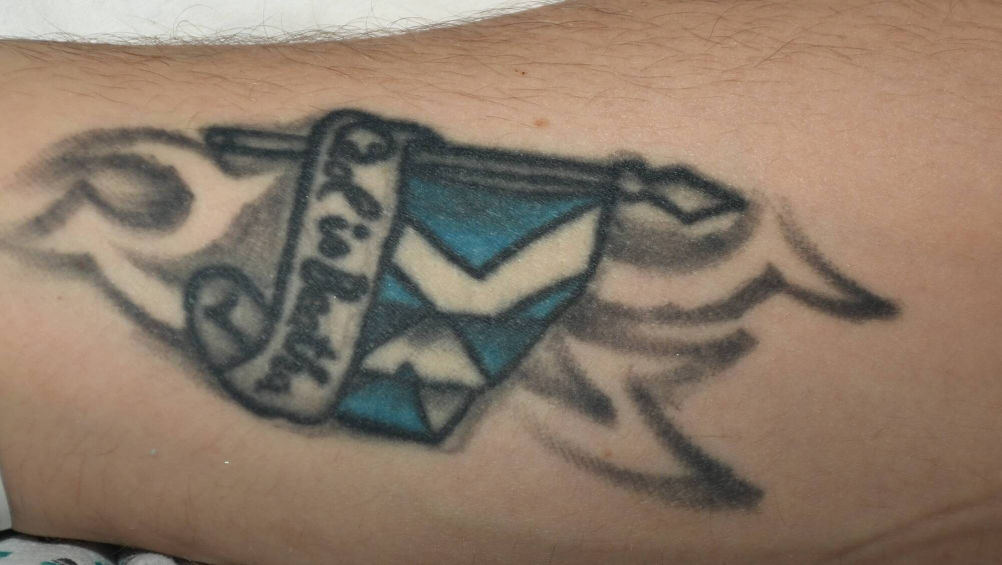 Gardaí have not been able to identify the victim of an assault in Dublin and have released an image of the man's blue and white tattoo with the words ‘ceol is beatha’ – or ‘music is life’ – on his right arm. Picture: An Garda Síochána 
