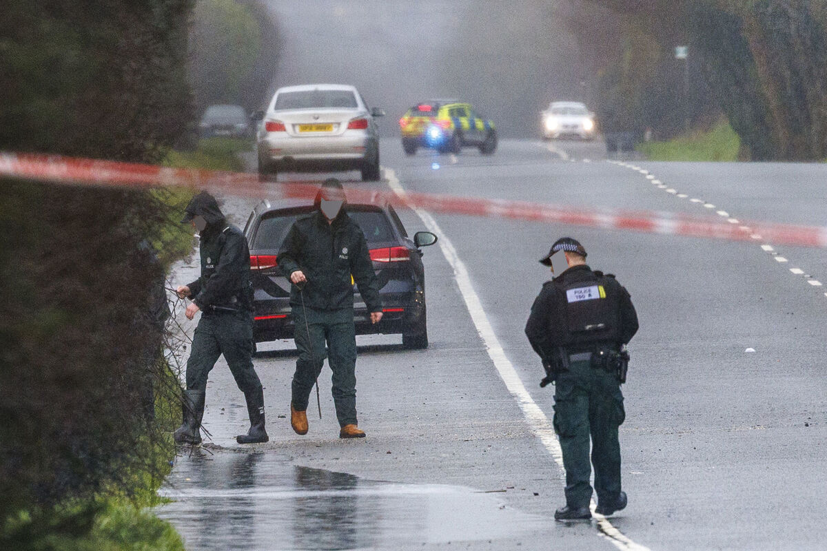 PSNI officers searching at the scene near Moy in Co Tyrone after three people died and four people were injured following a crash on Saturday night. Picture: Liam McBurney/PA