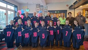 <p>The Scoil Mhuire team receive their jerseys from Ms Twomey (vice-principal) and with Amy Nangle, 2023 captain, ahead of Wednesday’s So Hockey Munster Senior Cup final. Also included is Scoil Mhuire head coach, Dave Egner. Picture: Andrew Noonan</p>