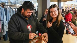 <p>Ray Nash and Alicia Healy opening the first packages. Picture: Noel Sweeney</p>