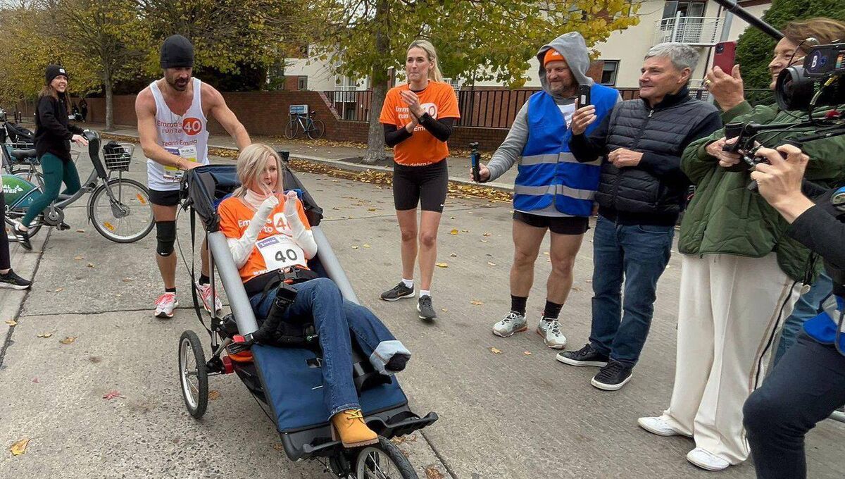 Hollywood star Colin Farrell meets friend Emma Fogarty 4km from the finish line of the Irish Life Dublin Marathon. Completing a mammoth fundraising drive for Debra. Photo: Alejandra Livschitz/Debra