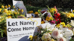 A memorial grows outside the home of Nancy Guthrie (Felicia Fonseca/AP) A memorial grows outside the home of Nancy Guthrie (Felicia Fonseca/AP)