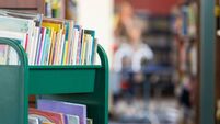 Book cart full of childrens' books in public school library