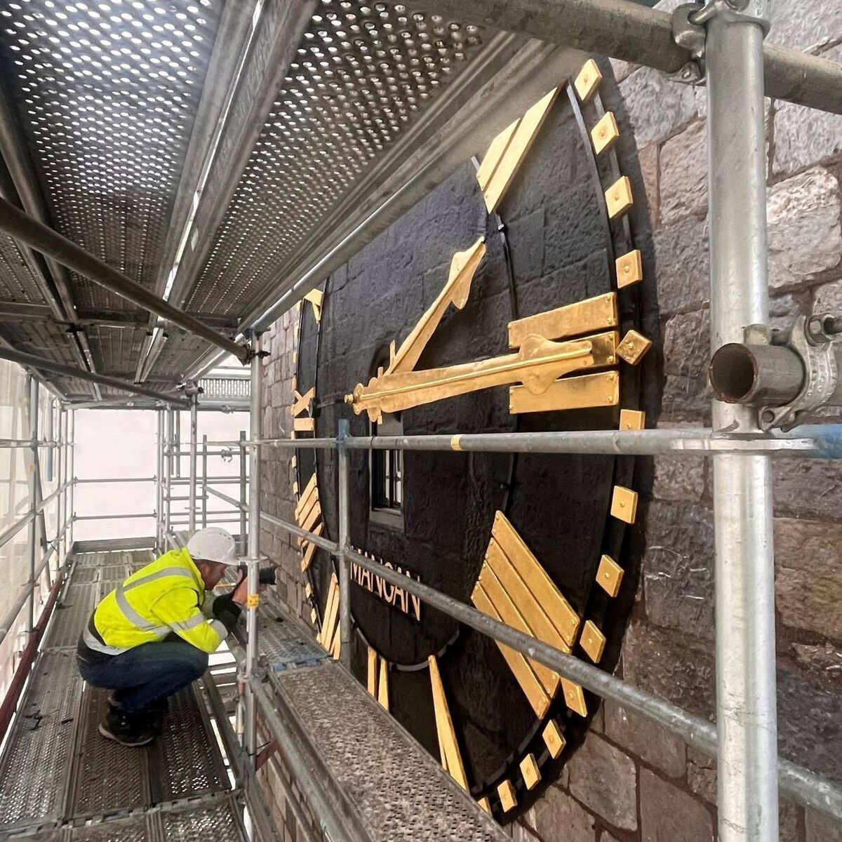 Restoration being carried out on the clock face. Restoration being carried out on the clock face.