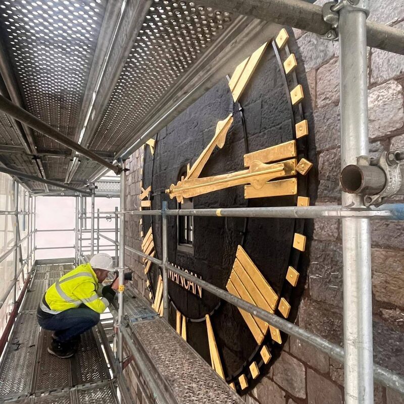 Restoration being carried out on the clock face. 