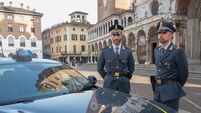 two tax force police officers in duty near city duomo square and cathedral in Cremona, Lombardy Italy