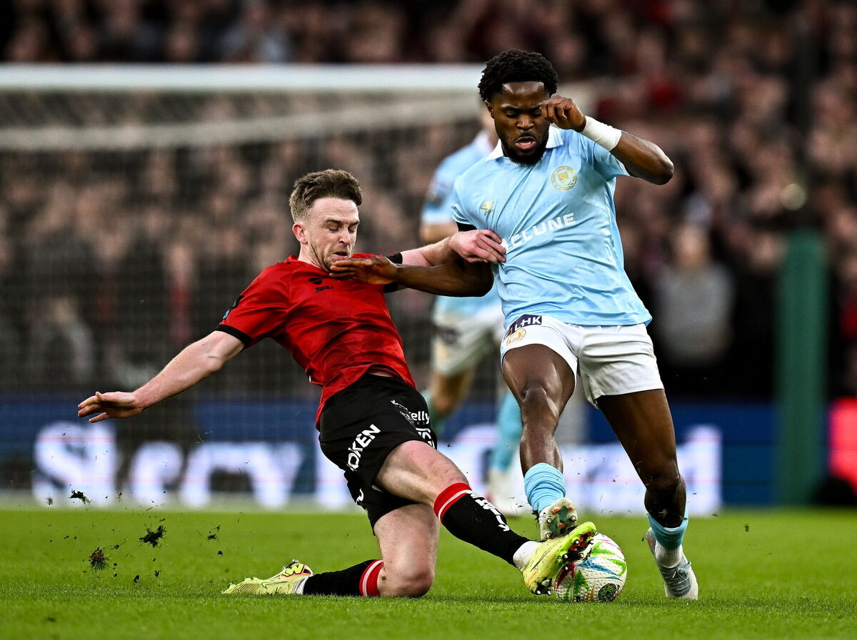 Glory Nzingo of St Patrick's Athletic is tackled by Power during the Men's Premier Division match at the Aviva Stadium. Pic: Seb Daly/Sportsfile