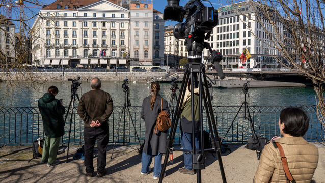 <p>Journalists gather outside the Bergues Hotel in Geneva (Martial Trezzini/Keystone/AP)</p>