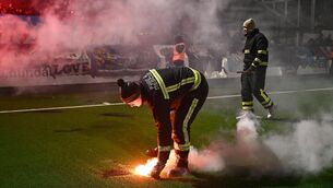 <p>Fire stewards remove flares from the pitch before the SSE Airtricity Men's Premier Division match between Dundalk and Drogheda United at Oriel Park. Pic: Ben McShane/Sportsfile</p>