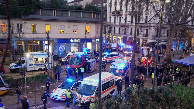 Emergency cervices work at the scene of a tram derailment (Luca Bruno/AP)