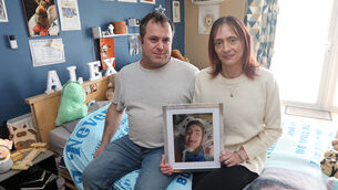 <p> Michael Power and Maggie Butler with a photo of Alex, 14, in his room at their home in Killenaule, Co Tipperary. They cared for him until his death in October last year. Picture: Brendan Gleeson</p>
