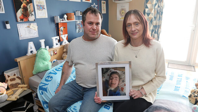 <p> Michael Power and Maggie Butler with a photo of Alex, 14, in his room at their home in Killenaule, Co Tipperary. They cared for him until his death in October last year. Picture: Brendan Gleeson</p>