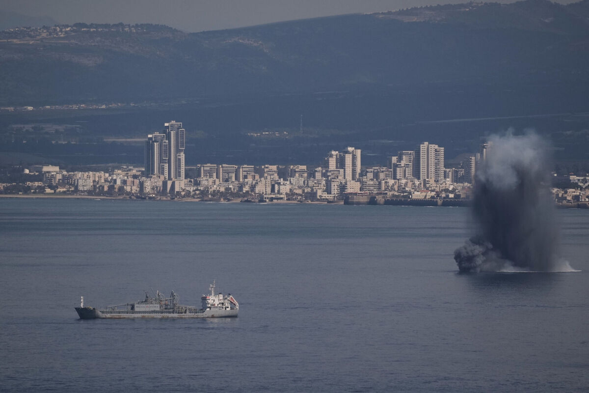 An incoming projectile explodes over the water as Israel issues a nationwide alert following its strikes on Iran, in Haifa Bay, northern Israel, Saturday, Feb. 28, 2026. (AP Photo/Leo Correa)