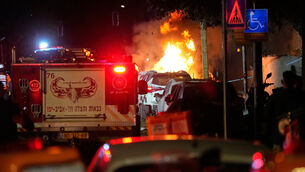 <p>Firefighters try to extinguish flames at the site of a direct hit by an Iranian missile strike in Tel Aviv (Ohad Zwigenberg/AP)</p>