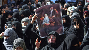 <p>Shiite Muslims hold the portraits of Iranian leaders during a rally to condemn the killing of Iranian Supreme Leader Ayatollah Ali Khamenei. Picture: AP Photo/Arshad Butt</p>