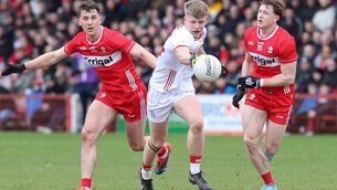 <p>Cork’s Dara Sheedy with Derry’s Shane McGuigan and Matthew Downey. Pic: INPHO/Lorcan Doherty</p>
