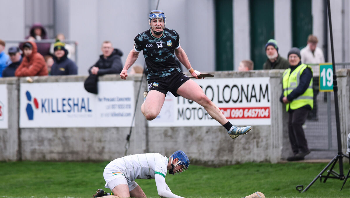 Limerick's Shane O'Brien celebrates after scoring his side's first goal of the match despite Liam Hoare of Offaly. Pic: Tom Maher/Inpho